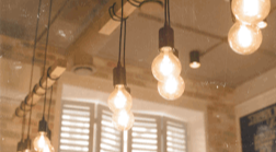 Vintage Tesla-era electrical apparatus glowing in a dark room